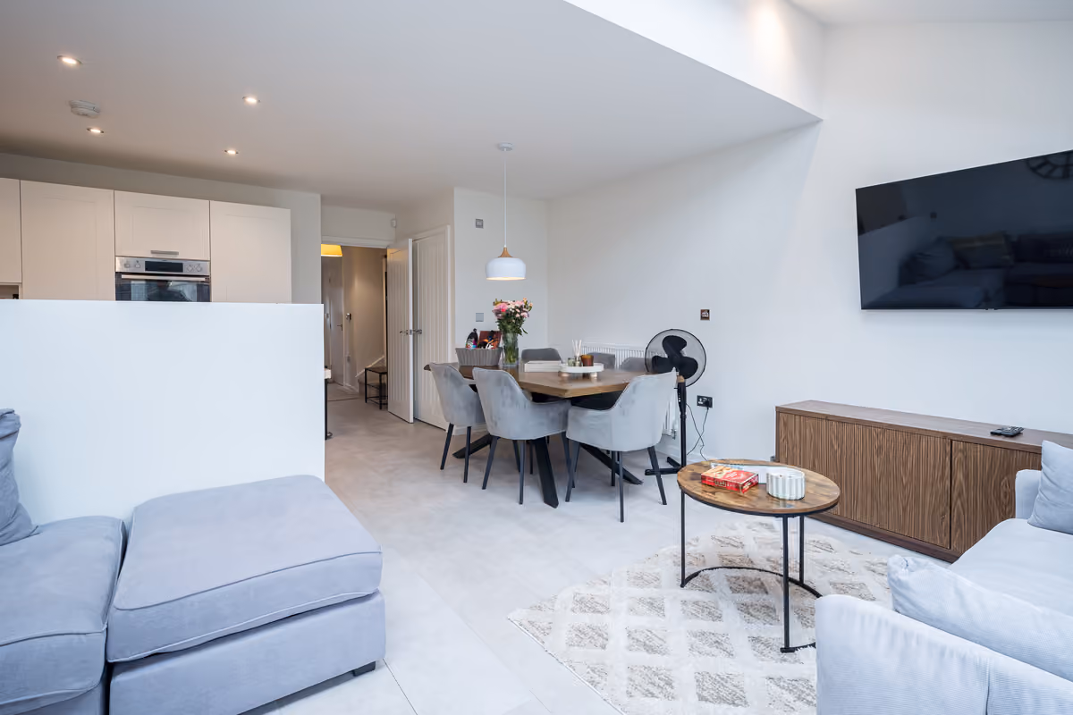 Open-plan living and dining space with wall-mounted smart TV