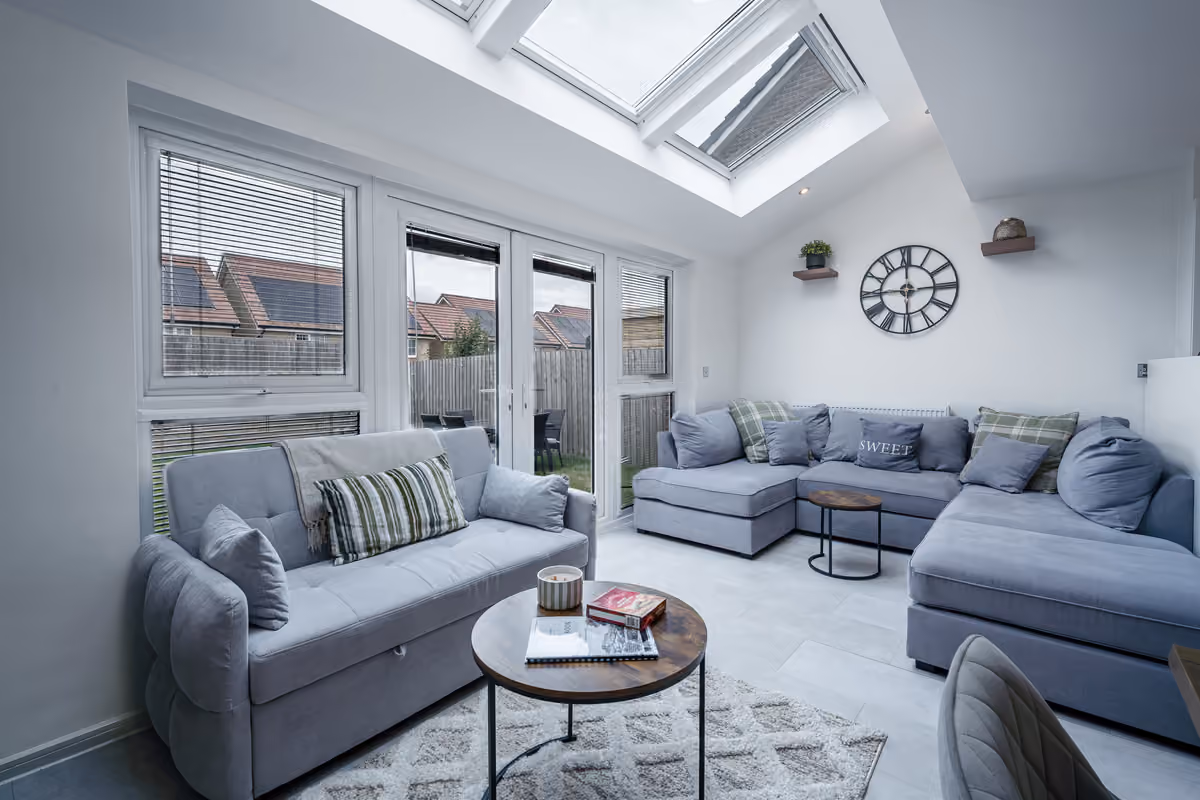 Bright living room with corner sofa beneath the skylight